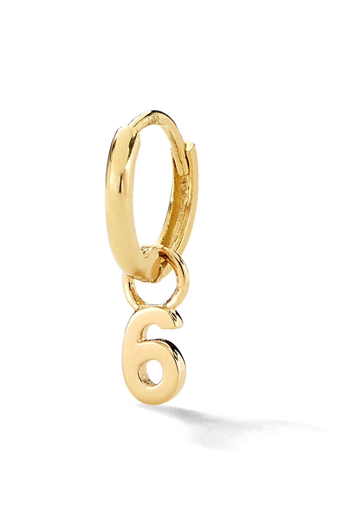 A number "6' Gold hoop huggie earring against a white background