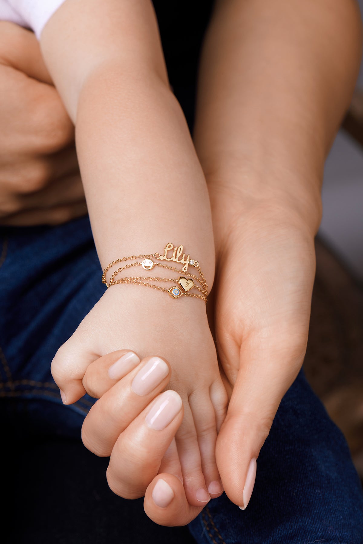 baby girl arm closeup with bracelet ring in tiny finger colorful floral  dress Stock Photo - Alamy